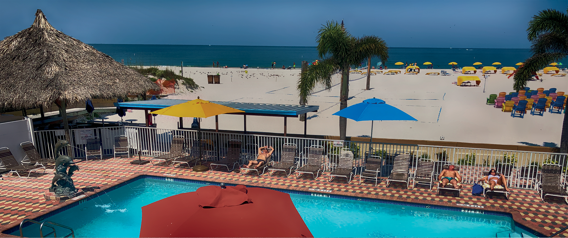 A woman's legs hang out of the window of a pink car parked near oceanfront resorts.